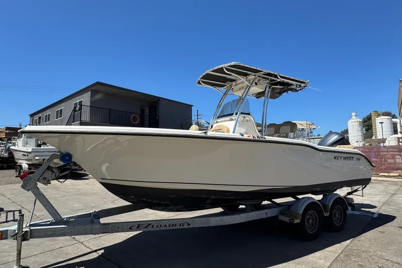Slide: The Image of 2019 Key West 239 FS boat on trailer under clear blue sky. - 6