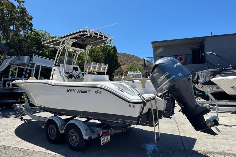 Slide: The Image of 2019 Key West 239 FS boat on trailer with Yamaha 250 engine, parked outdoors. - 8