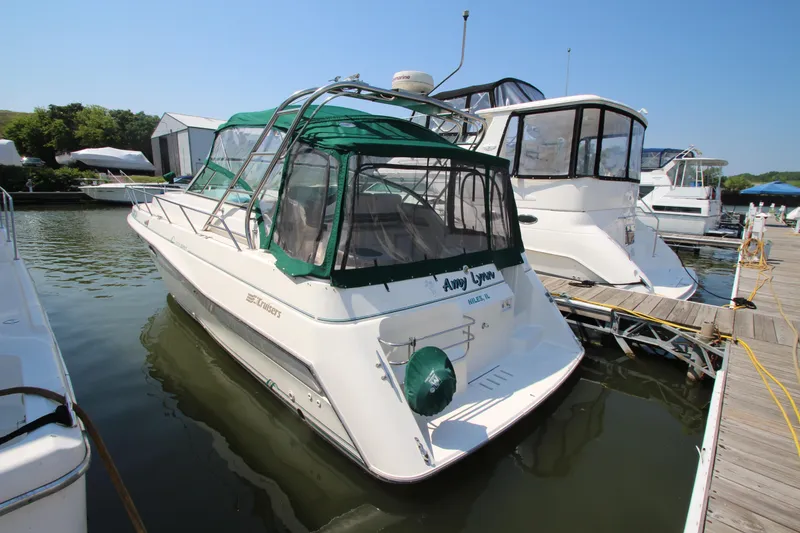 The Image of 1994 Cruisers Yachts Esprit 3775 docked at marina with green canopy. - 0
