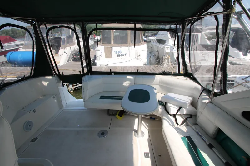 Slide: The Image of 1994 Cruisers Yachts Esprit 3775 interior with seating and table, docked at marina. - 10