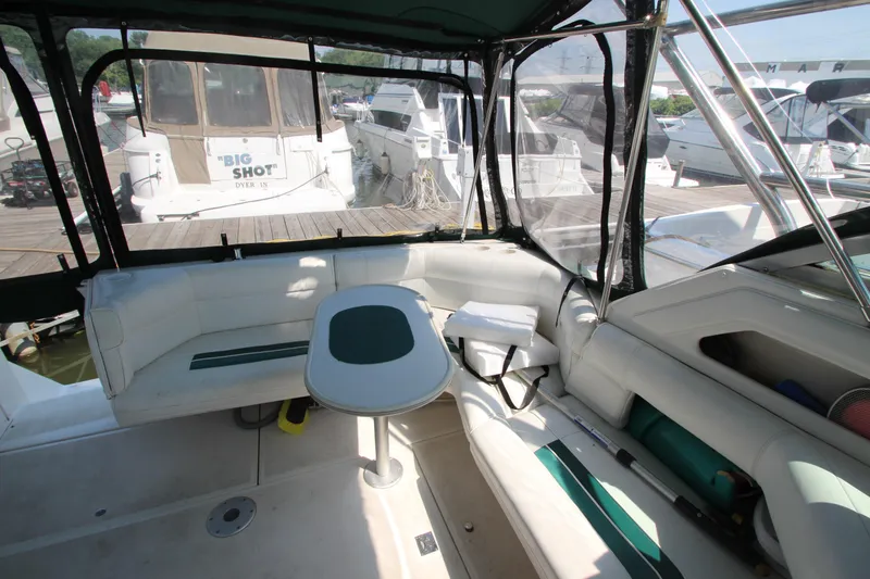 Slide: The Image of 1994 Cruisers Yachts Esprit 3775 interior with seating and table, docked at marina. - 11