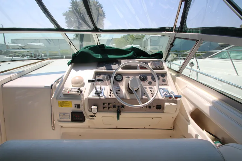 Slide: The Image of 1994 Cruisers Yachts Esprit 3775 helm with steering wheel and control panel. - 12