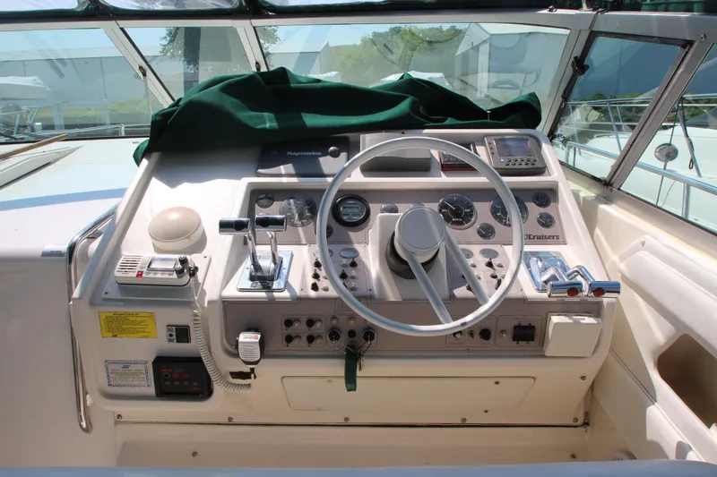 Slide: The Image of 1994 Cruisers Yachts Esprit 3775 helm with steering wheel, controls, and navigation instruments. - 13