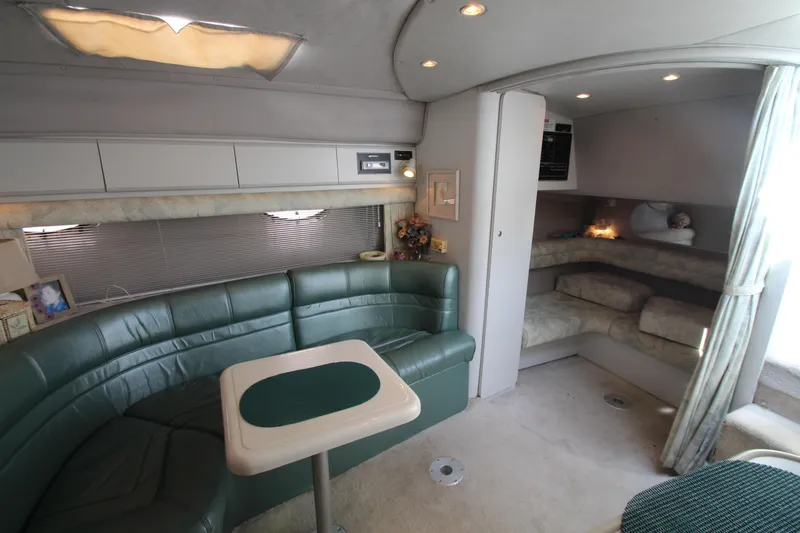 Slide: The Image of Luxurious 1994 Cruisers Yachts Esprit 3775 interior with green leather seating and cozy cabin space. - 18
