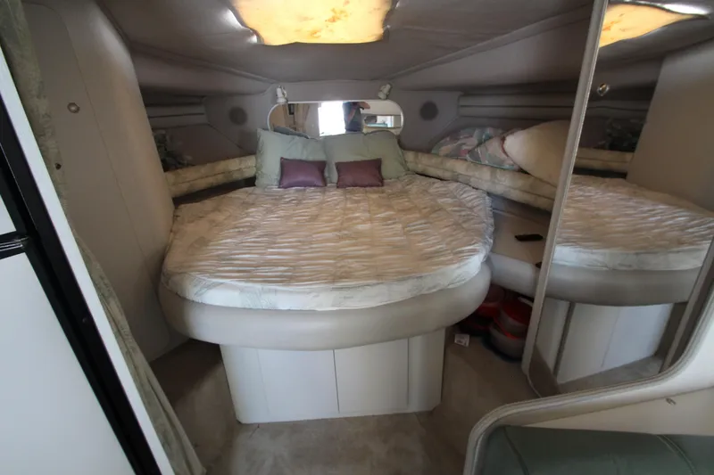 Slide: The Image of 1994 Cruisers Yachts Esprit 3775 cabin interior with cozy bed and mirrored walls. - 27