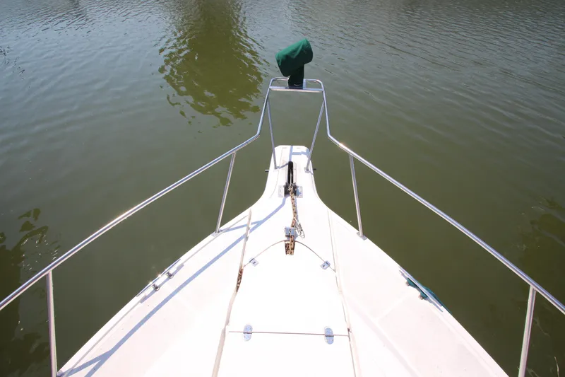 Slide: The Image of Bow view of 1994 Cruisers Yachts Esprit 3775 on calm water. - 4