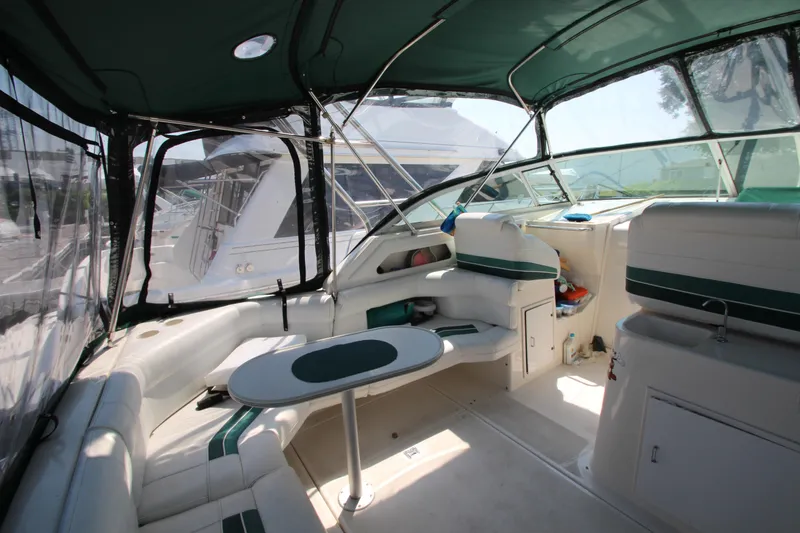 Slide: The Image of 1994 Cruisers Yachts Esprit 3775 interior with seating and table, featuring green accents. - 7