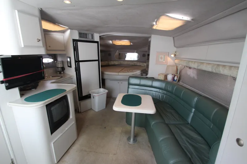 Slide: The Image of Interior of 1994 Cruisers Yachts Esprit 3775 with kitchen, seating, and sleeping area. - 14
