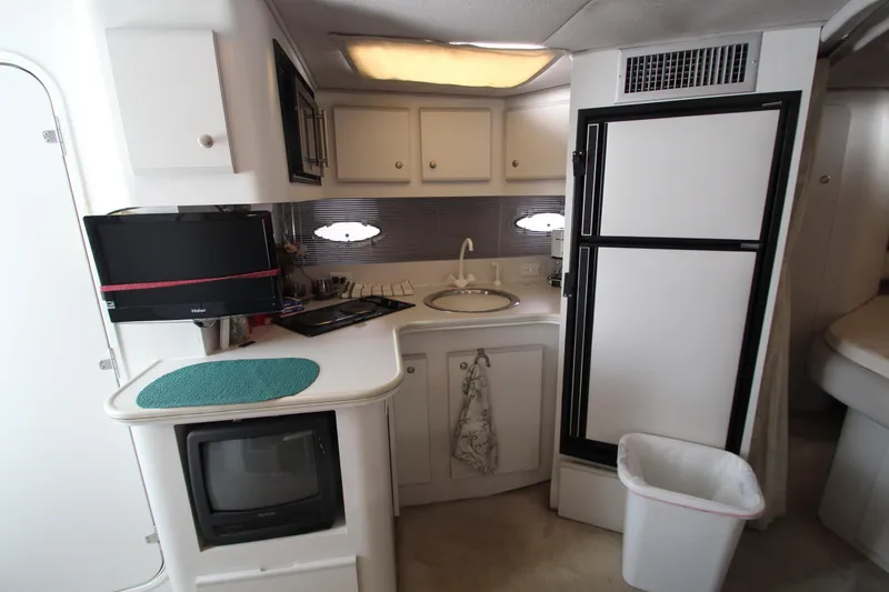 Slide: The Image of 1994 Cruisers Yachts Esprit 3775 interior with kitchenette, sink, and appliances. - 16