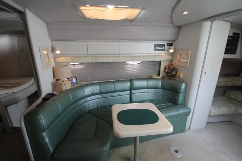 Slide: The Image of Interior of 1994 Cruisers Yachts Esprit 3775 with green leather seating and compact table. - 19