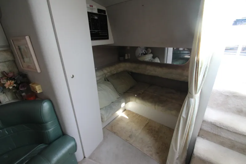 Slide: The Image of 1994 Cruisers Yachts Esprit 3775 interior cabin with cozy seating and soft lighting. - 24