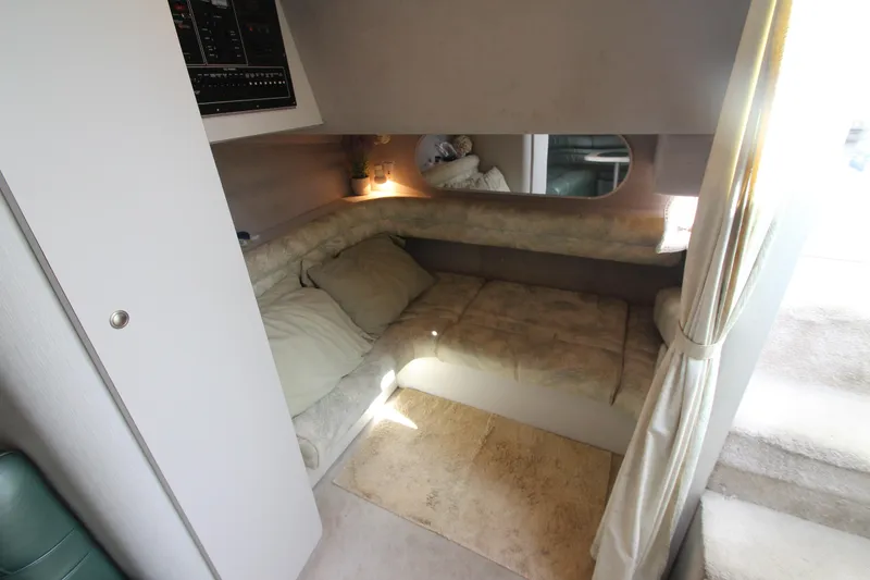 Slide: The Image of 1994 Cruisers Yachts Esprit 3775 interior cabin with cozy seating and soft lighting. - 28