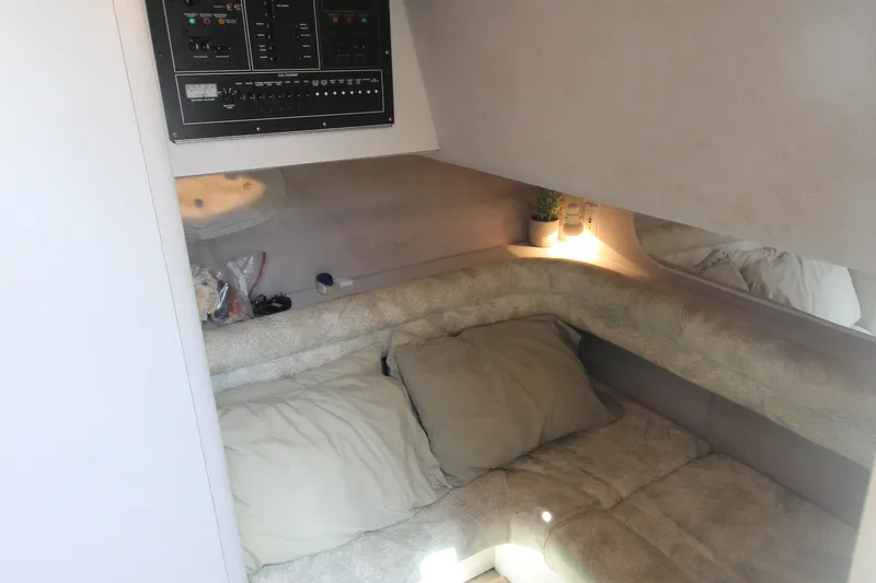 Slide: The Image of 1994 Cruisers Yachts Esprit 3775 cabin interior with cozy bedding and control panel. - 30