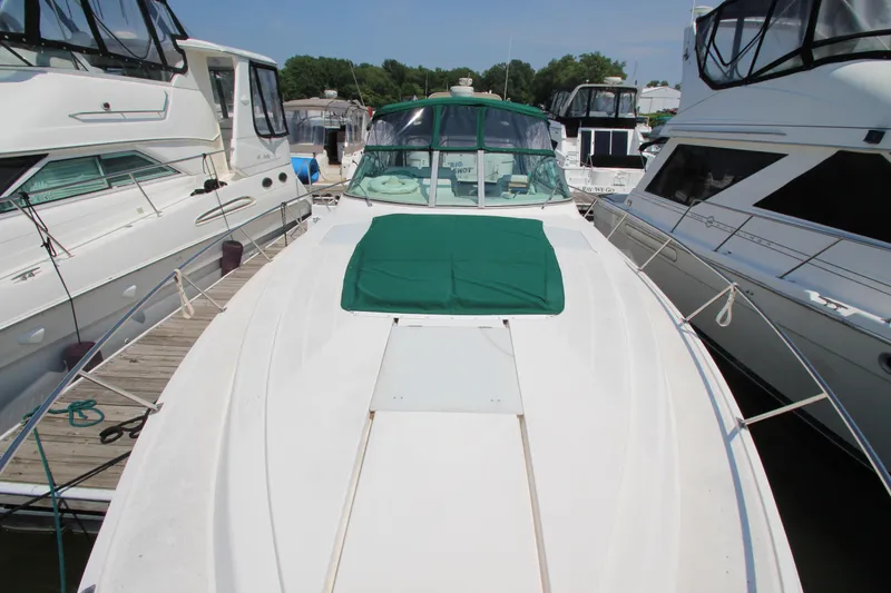 Slide: The Image of 1994 Cruisers Yachts Esprit 3775 docked, featuring a green cover and sleek white design. - 5