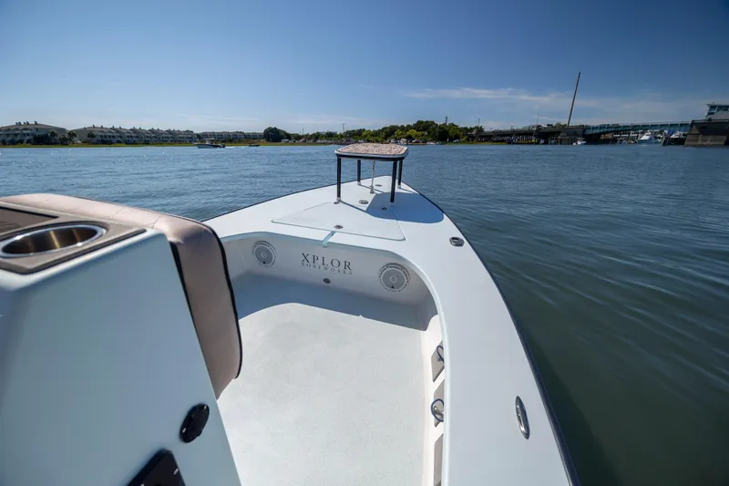 Slide: The Image of Xplor X18 boat on calm water, showcasing sleek design and spacious deck, 2018 model. - 11