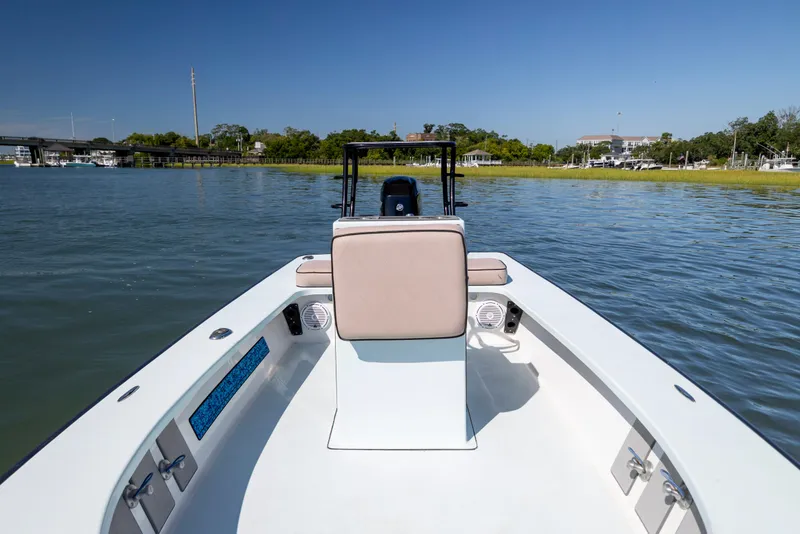 Slide: The Image of 2018 Xplor X18 boat on calm water, featuring sleek design and spacious deck. - 13