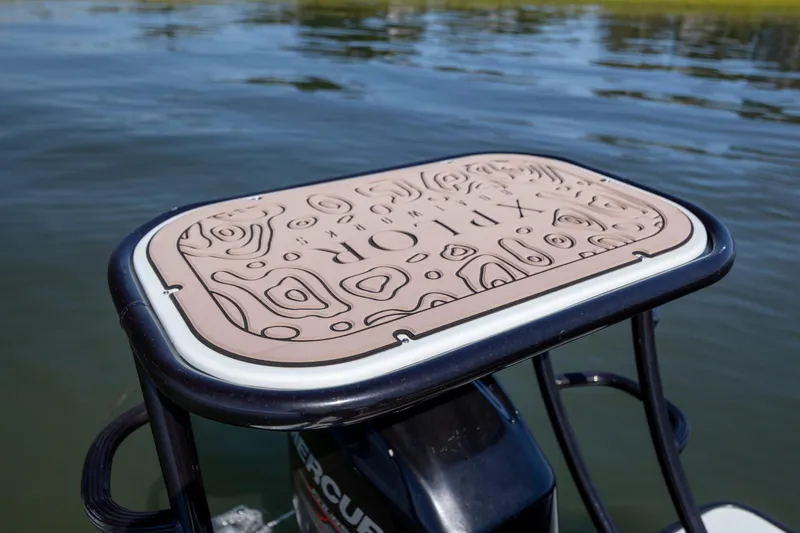 Slide: The Image of Xplor X18 boat platform with embossed design, floating on calm water, 2018 model. - 18