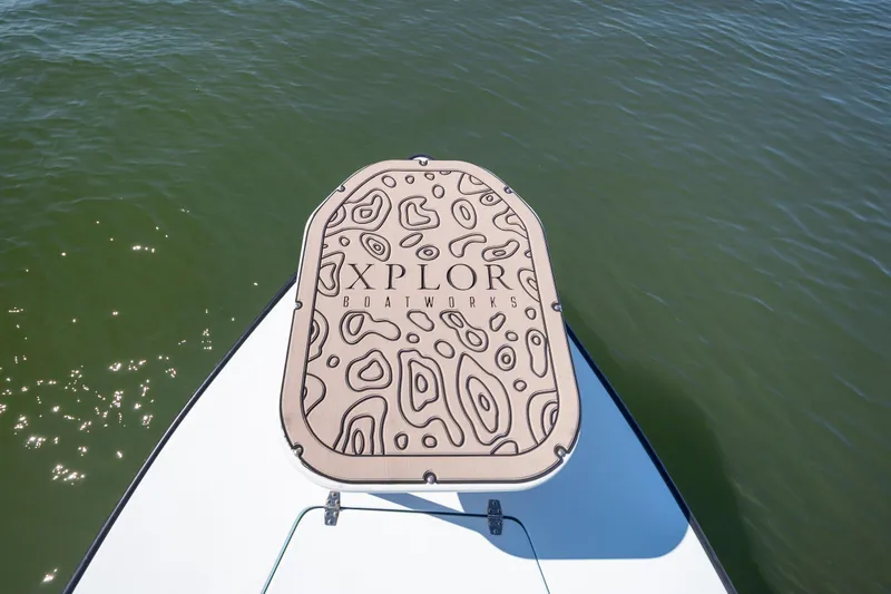 Slide: The Image of Bow of 2018 Xplor X18 boat with custom deck pad on water. - 23