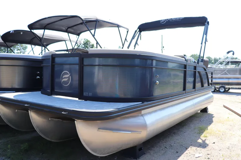 Slide: The Image of 2025 Flagship Discover 22 RF pontoon boat with sleek design and canopy. - 0