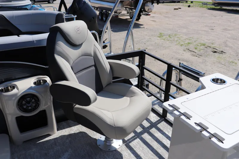 Slide: The Image of Captain's chair on 2025 Flagship Discover 22 RF boat, featuring cup holders and a speaker. - 6