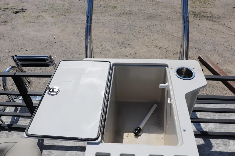 Slide: The Image of Open storage compartment on 2025 Flagship Discover 22 RF boat, featuring cup holder and ladder. - 9