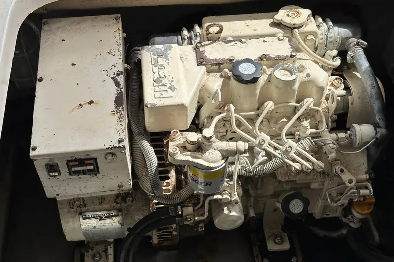 Slide: The Image of Engine compartment of a 2004 Mainship Pilot 30 boat, featuring a diesel engine. - 20