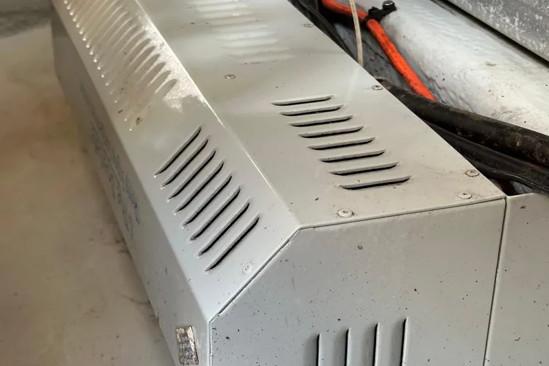 Slide: The Image of Close-up of a 2004 Mainship Pilot 30 engine compartment with visible ventilation slots. - 22