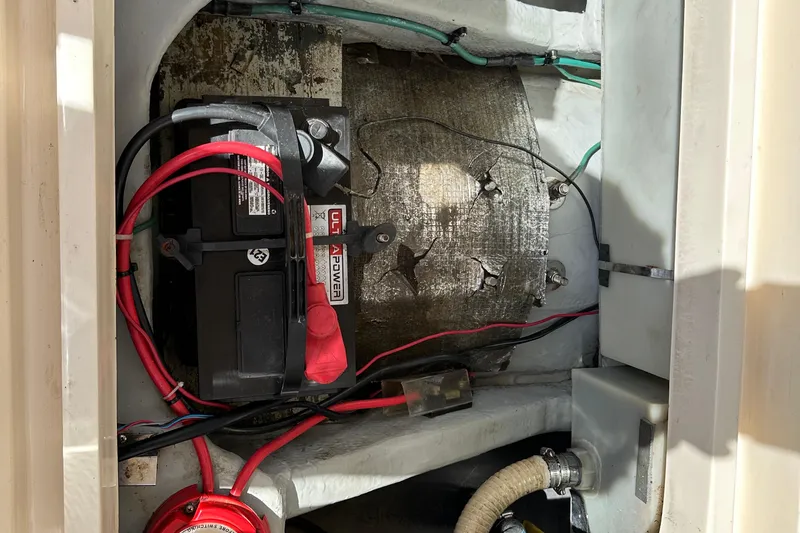 Slide: The Image of 2004 Mainship Pilot 30 engine compartment with battery and wiring. - 23