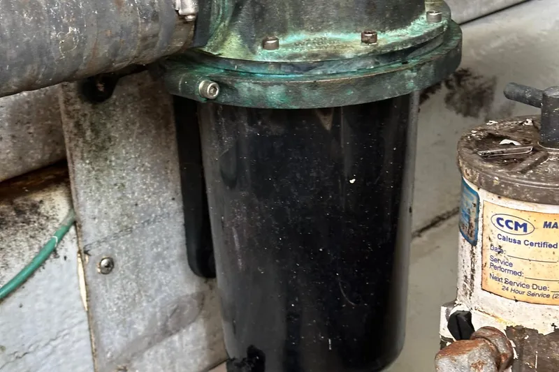 Slide: The Image of Engine compartment of a 2004 Mainship Pilot 30 with visible components and labels. - 25