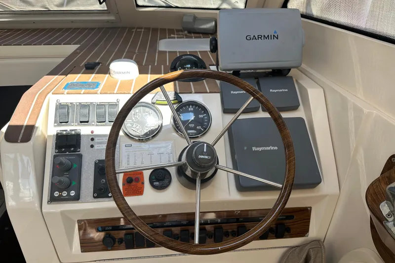 Slide: The Image of 2004 Mainship Pilot 30 helm with Garmin and Raymarine navigation equipment. - 7