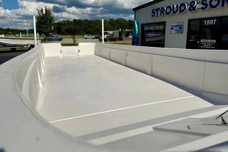 Slide: The Image of 2026 Carolina Skiff E24 DLX Kit Boat displayed at dealership, clear sky background. - 10