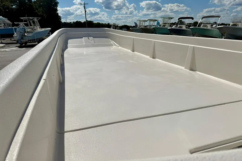 Slide: The Image of 2026 Carolina Skiff E24 DLX Kit Boat interior view under sunny sky. - 15