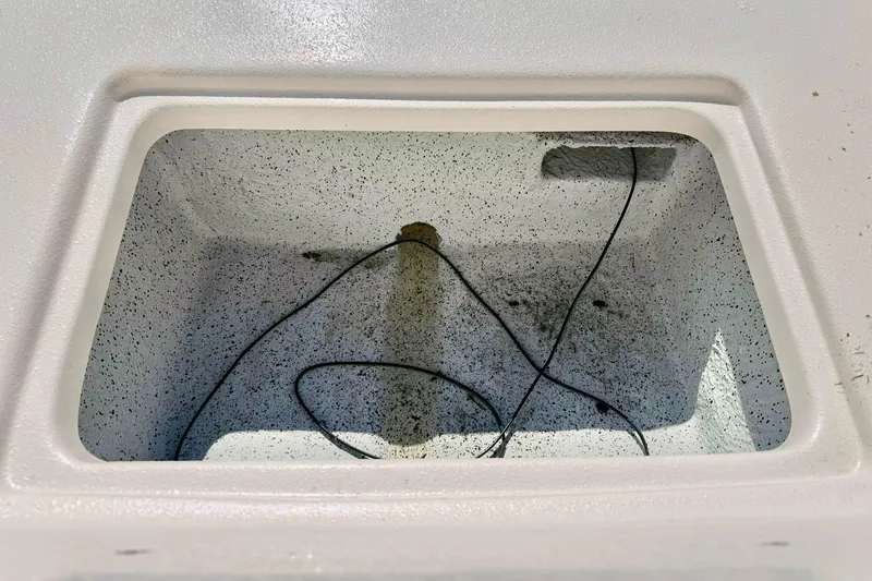 Slide: The Image of Interior compartment of 2026 Carolina Skiff E24 DLX Kit Boat, showing wiring and textured surface. - 18