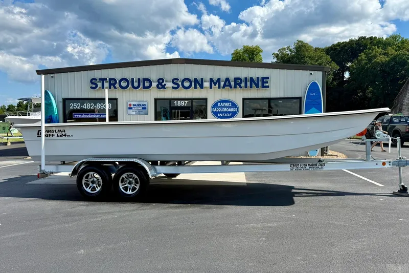 Slide: The Image of 2026 Carolina Skiff E24 DLX Kit Boat on trailer at Stroud & Son Marine dealership. - 5