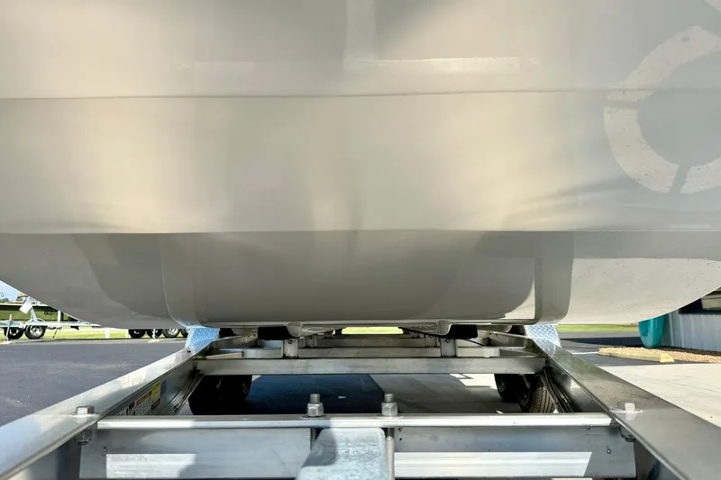 Slide: The Image of 2026 Carolina Skiff E24 DLX Kit Boat on trailer, underside view. - 7