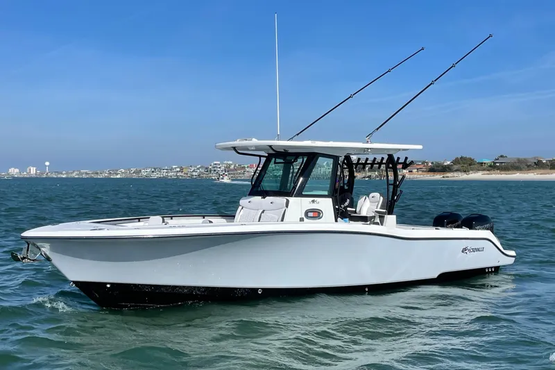 Slide: The Image of 2023 Crevalle 33 CSF boat on water, featuring sleek design and dual engines. - 0