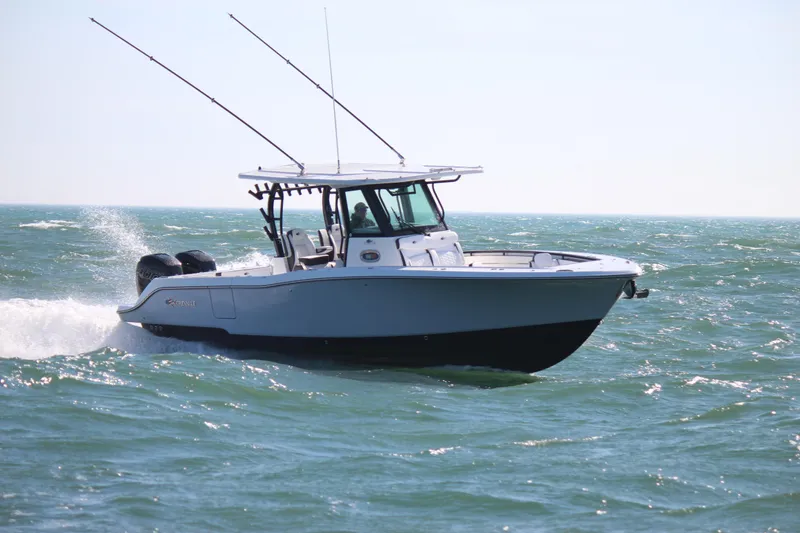 Slide: The Image of 2023 Crevalle 33 CSF boat cruising on open water with fishing rods. - 1