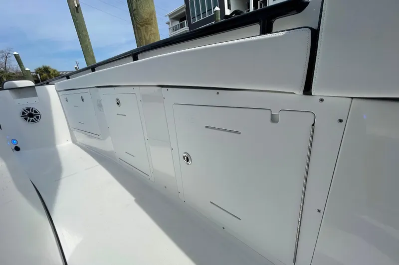 Slide: The Image of 2023 Crevalle 33 CSF boat interior with storage compartments and speaker. - 18