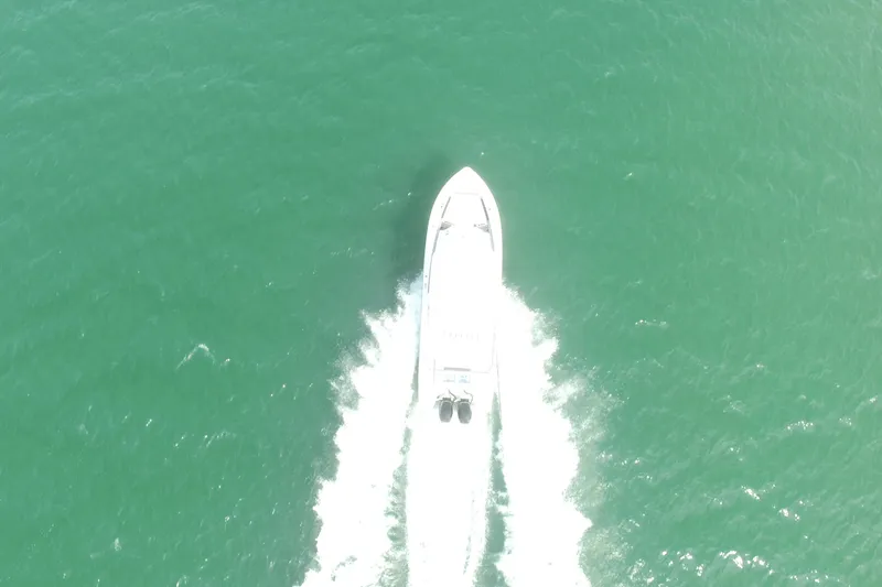 Slide: The Image of Aerial view of 2023 Crevalle 33 CSF boat cruising on open water. - 6
