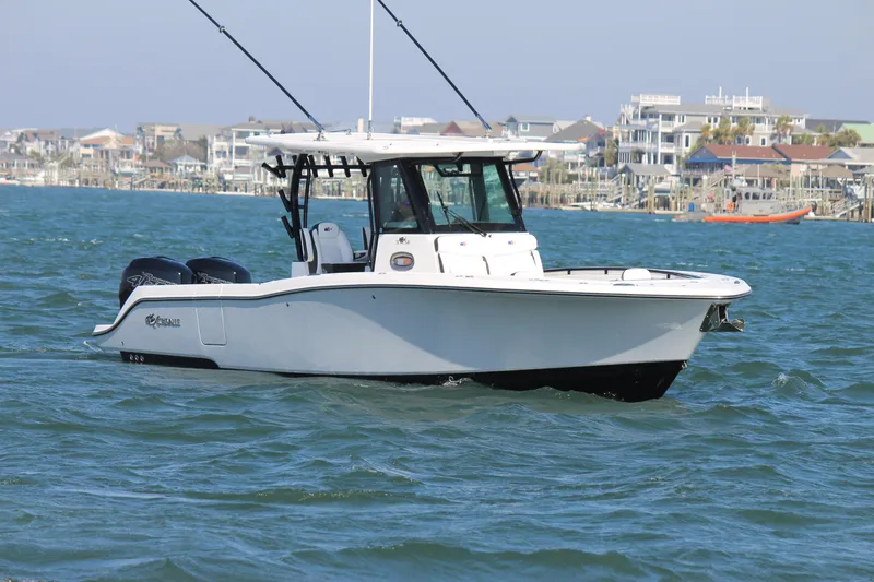 Slide: The Image of 2023 Crevalle 33 CSF boat on water, coastal background, clear sky. - 8