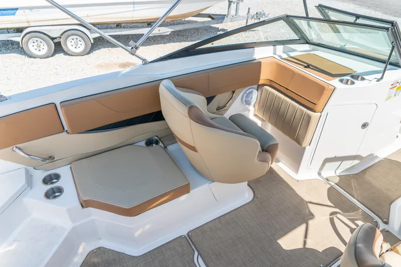 Slide: The Image of 2018 Sea Ray SPX 210 boat interior with tan seating and cup holders. - 13