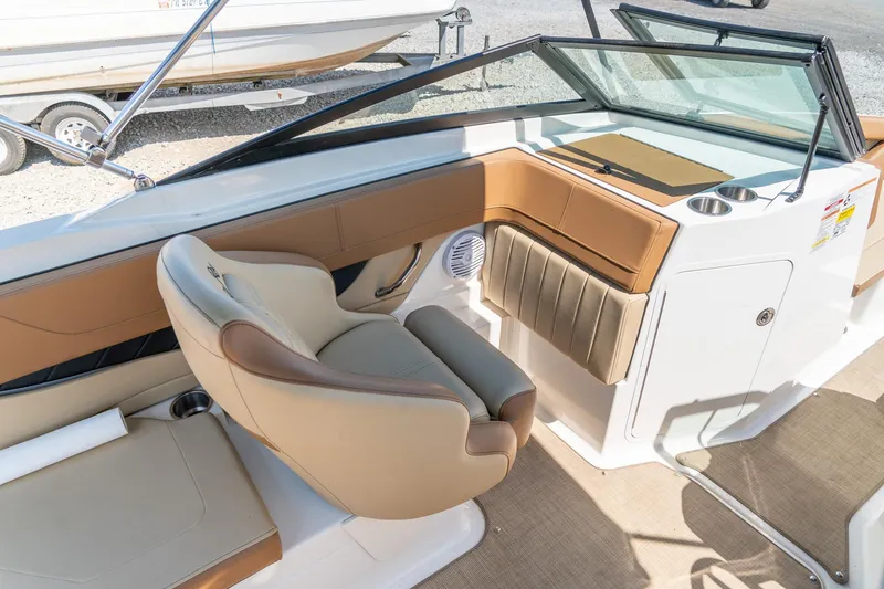 Slide: The Image of 2018 Sea Ray SPX 210 boat interior with beige seating and modern dashboard design. - 14