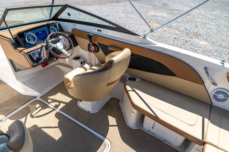 Slide: The Image of 2018 Sea Ray SPX 210 boat interior with tan seating and modern dashboard. - 15