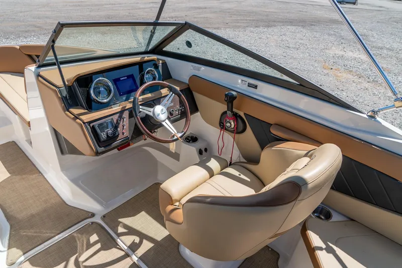 Slide: The Image of 2018 Sea Ray SPX 210 boat interior with steering wheel and dashboard controls. - 16
