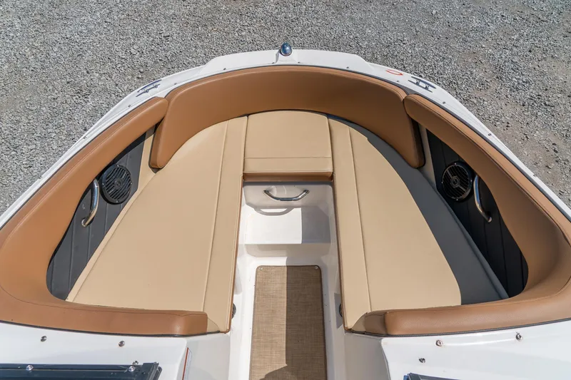 Slide: The Image of 2018 Sea Ray SPX 210 boat interior with tan seating and speakers. - 18