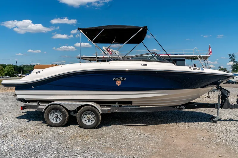 Slide: The Image of 2018 Sea Ray SPX 210 boat on trailer under clear blue sky. - 3