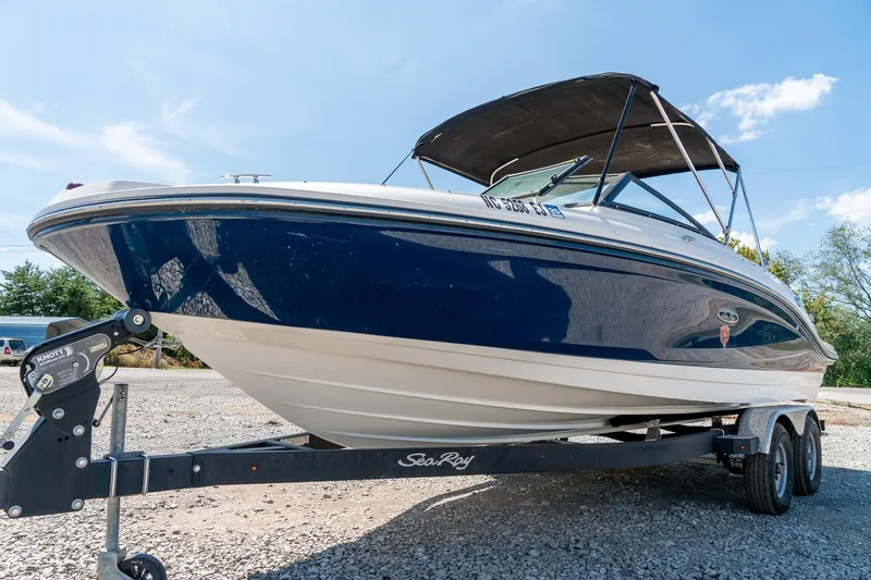 Slide: The Image of 2018 Sea Ray SPX 210 boat on trailer under clear blue sky. - 6