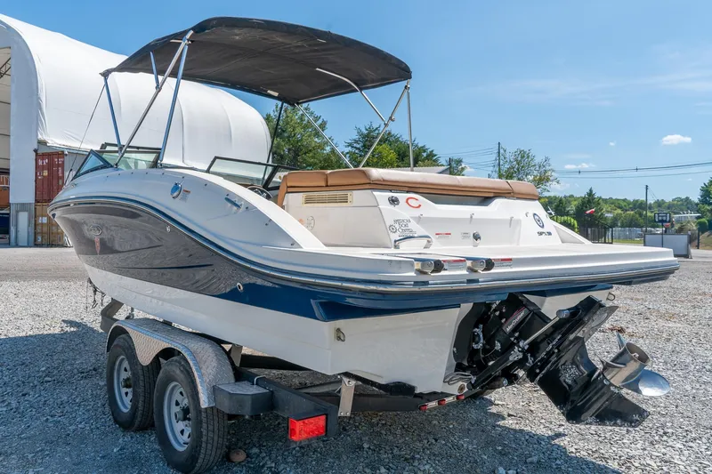 Slide: The Image of 2018 Sea Ray SPX 210 boat on trailer, outdoor setting, sunny day. - 7