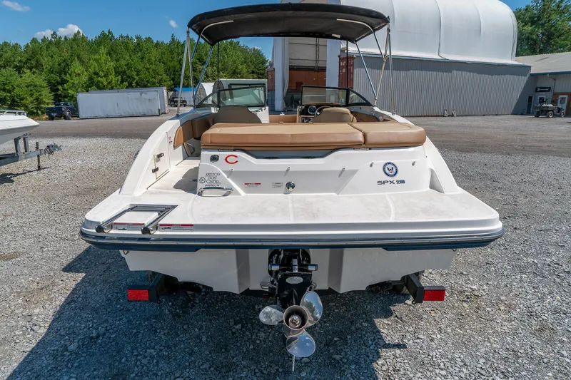Slide: The Image of 2018 Sea Ray SPX 210 boat, rear view, parked outdoors on gravel. - 8