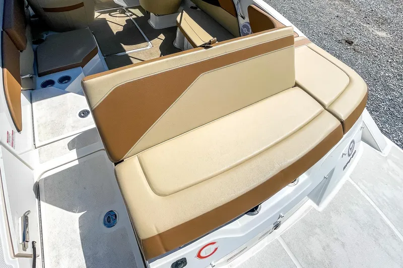 Slide: The Image of 2018 Sea Ray SPX 210 boat interior with tan and brown seating. - 9